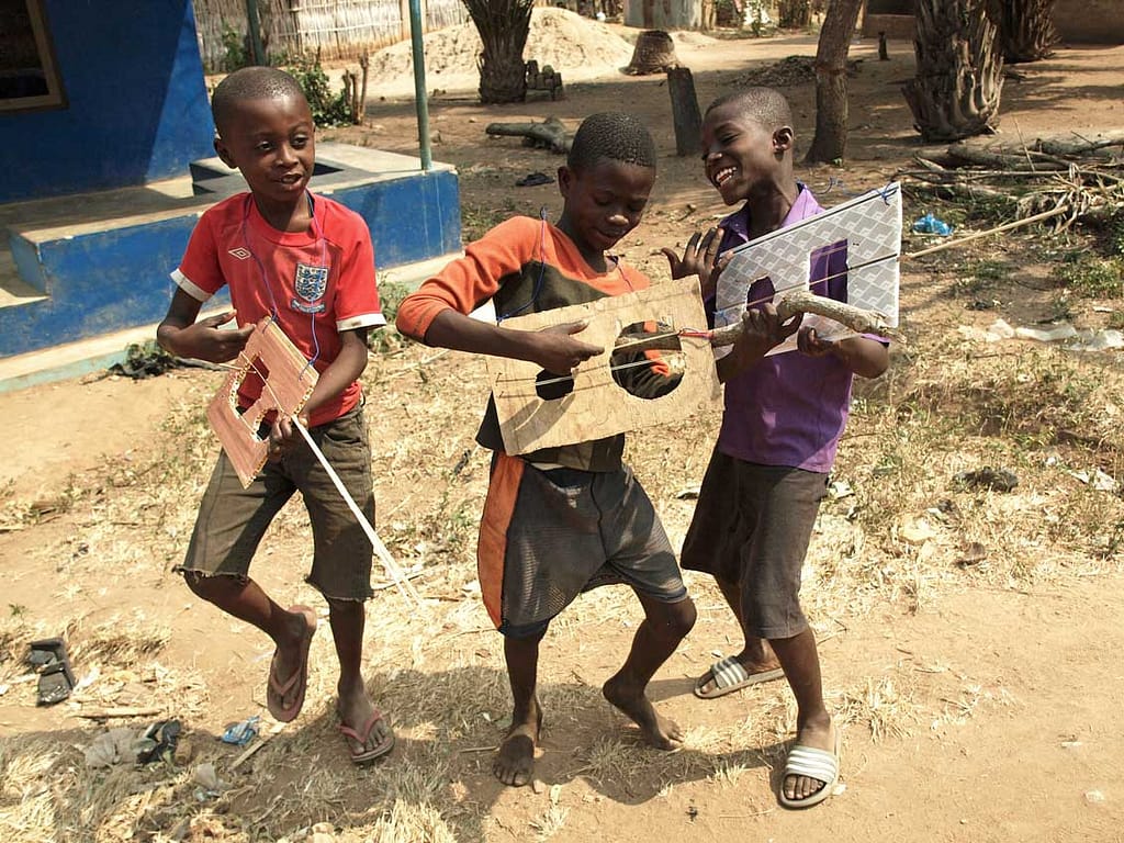 children playing with home-made instruments